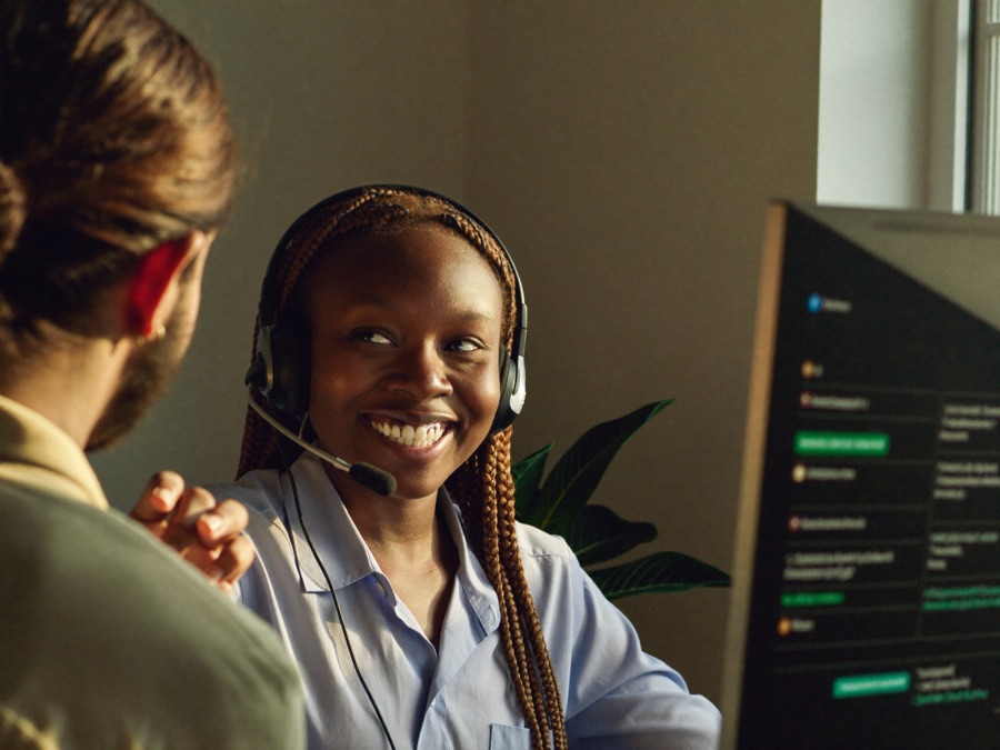 A customer support representative helping a customer by headset